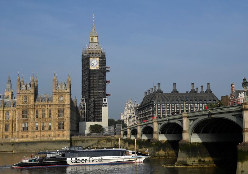 &copy; Reuters. FILE PHOTO: An Uber Boat river taxi sails past the Elizabeth Tower, more commonly known as Big Ben, as hands and dials on one of the clock faces are seen restored to the original Prussian blue colouring, whilst renovation works continue at the Houses of P