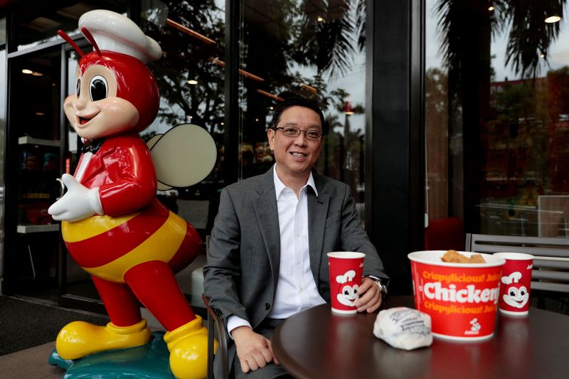 &copy; Reuters. FILE PHOTO: Ernesto Tanmantiong, President and CEO of Jollibee Foods Corp., poses with Jollibee products outside a Jollibee branch in Pasig City, Metro Manila, Philippines, July 30, 2019. REUTERS/Eloisa Lopez/File Photo