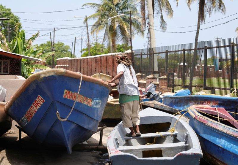 © Reuters. A fisherman checks a boat that was pulled from the water ahead of the arrival of Hurricane Beryl, in Port Royal, Jamaica July 2, 2024. REUTERS/Gilbert Bellamy