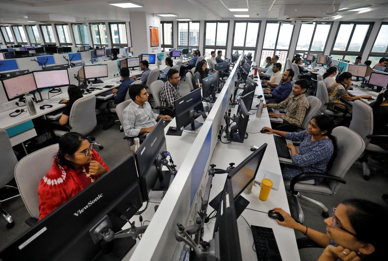 © Reuters. FILE PHOTO: Employees work on their terminals inside the office of Manubhai & Shah LLP, a local accounting firm, in Ahmedabad, India, July 4, 2023. REUTERS/Amit Dave/File Photo