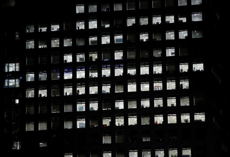 © Reuters. FILE PHOTO: Office lighting is seen through windows of a high-rise office building in Tokyo July 31, 2014.  REUTERS/Issei Kato/File Photo
