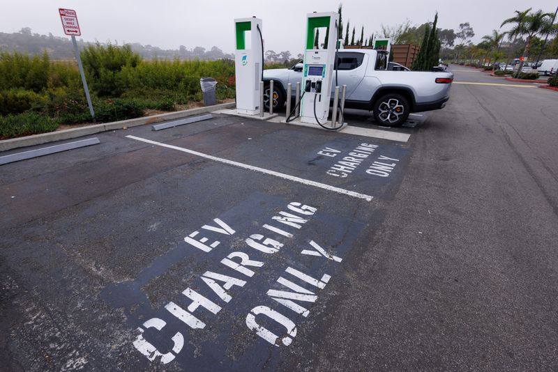 &copy; Reuters. FILE PHOTO: Electric vehicle chargers from Electrify America are shown in a shopping center parking lot in Oceanside, California, U.S.,October 19, 2023.     REUTERS/Mike Blake/File Photo