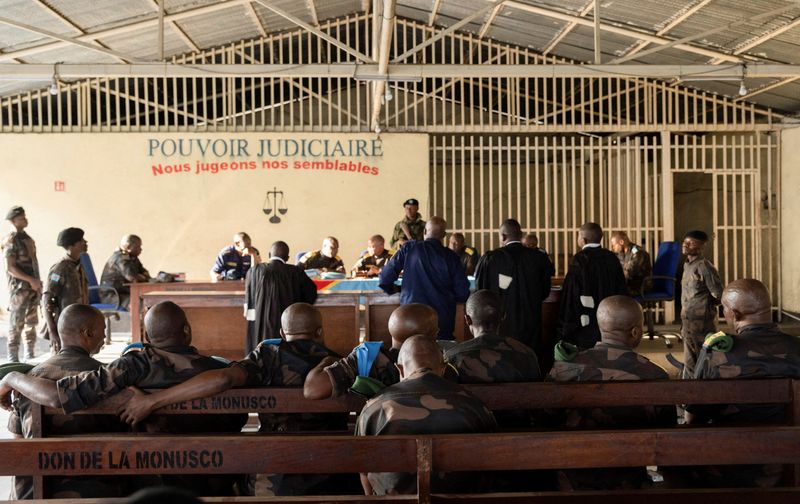 © Reuters. FILE PHOTO: Members of the Congolese army sentenced to death for desertion and cowardice when fighting M23 rebels sit inside a military courtroom during their trial in Goma, North Kivu province, Democratic Republic of Congo, May 3, 2024. REUTERS/Arlette Bashizi/File Photo