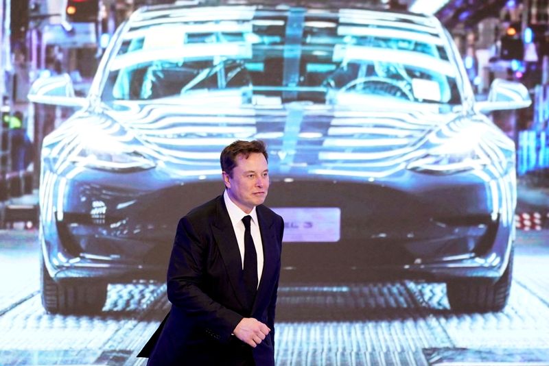 © Reuters. FILE PHOTO: Tesla Inc. Chief Executive Elon Musk walks next to a screen showing an image of a Tesla Model 3 car during the opening ceremony of Tesla's China-made Model Y program in Shanghai, China, January 7, 2020. REUTERS/Aly Song//File photo