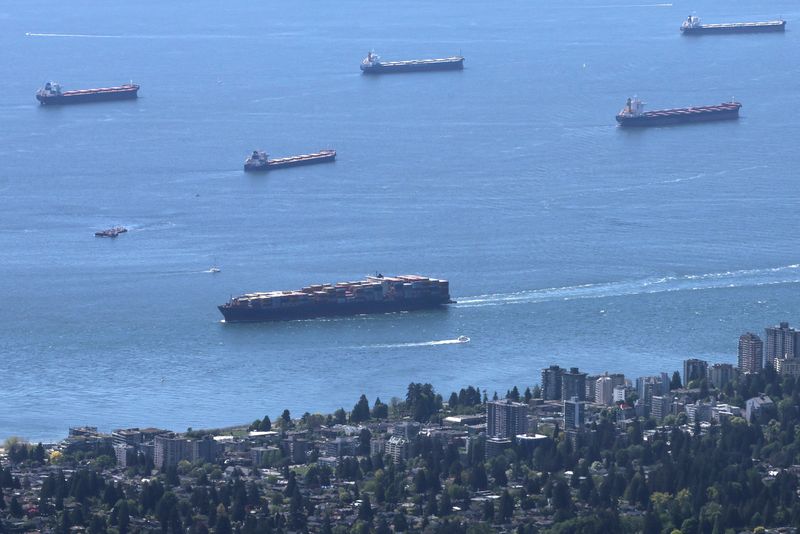 &copy; Reuters. FILE PHOTO: A container ship makes its way into the Port of Vancouver past vessels at anchor in English Bay, as seen from Grouse Mountain in North Vancouver, British Columbia, Canada May 10, 2024. REUTERS/Chris Helgren/File Photo