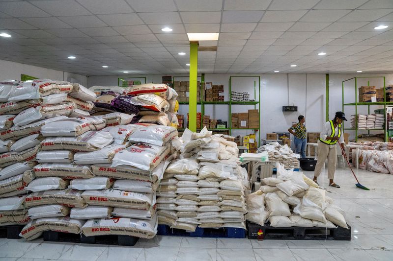 &copy; Reuters. FILE PHOTO: A volunteer sweeps the floor at the Lagos Food Bank warehouse in Lagos, Nigeria, March 23, 2024. REUTERS/Marvellous Durowaiye/File Photo