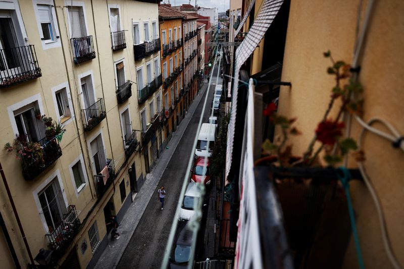 © Reuters. FILE PHOTO: A person walks on the street of the rented flat where Carmen Cajamarca, 67, lives in the neighbourhood of Lavapies in Madrid, Spain, June 10, 2024. REUTERS/Susana Vera/File Photo