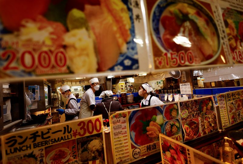 © Reuters. FILE PHOTO: Employees of a seafood restaurant work in their kitchen space at Tsukiji Outer Market in Tokyo, Japan, February 15, 2024.  REUTERS/Issei Kato/File Photo