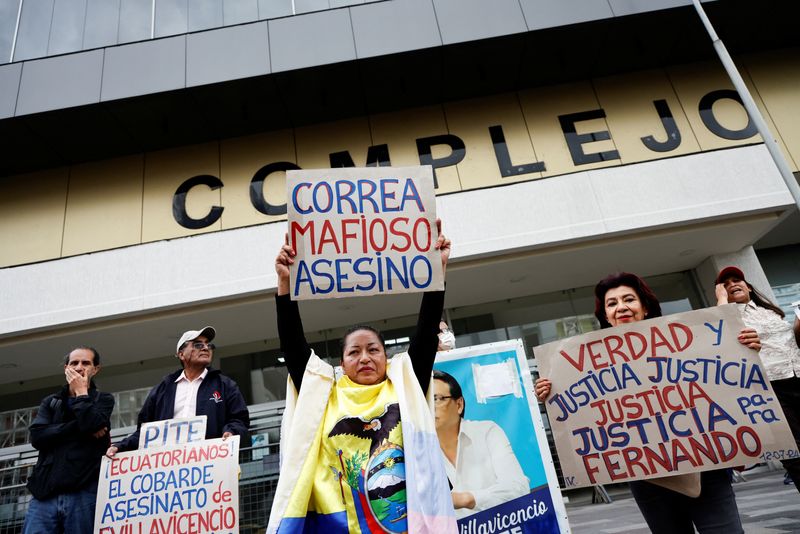 © Reuters. A woman holds a sign reading 