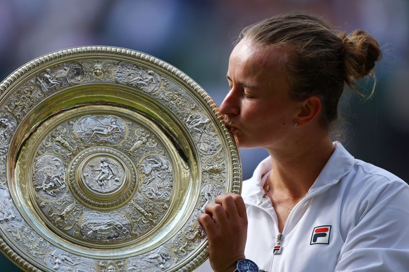 &copy; Reuters. Tennis - Wimbledon - All England Lawn Tennis and Croquet Club, London, Britain - July 13, 2024 Czech Republic's Barbora Krejcikova celebrates with the trophy after winning her final against Italy's Jasmine Paolini REUTERS/Matthew Childs