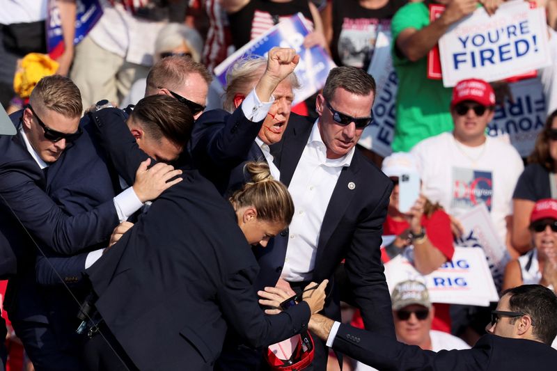 &copy; Reuters. Republican presidential candidate and former U.S. President Donald Trump is assisted by U.S. Secret Service personnel after gunfire rang out during a campaign rally at the Butler Farm Show in Butler, Pennsylvania, U.S., July 13, 2024. REUTERS/Brendan McDe