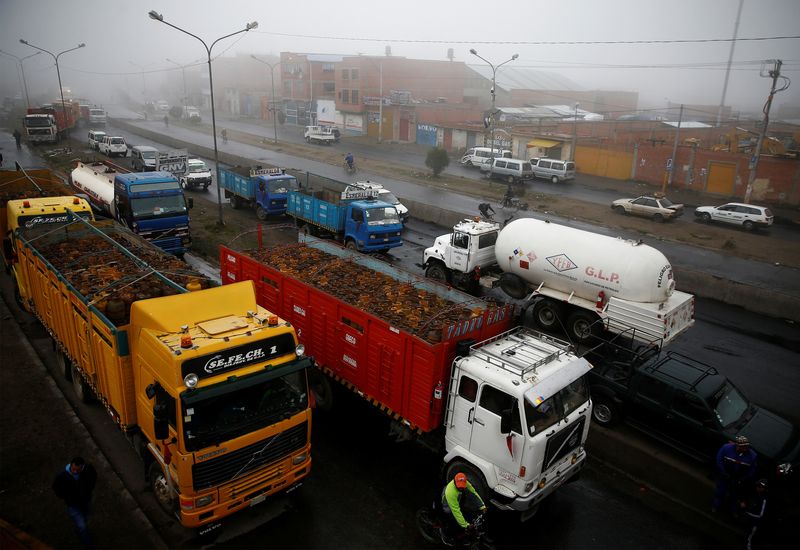 &copy; Reuters. Trucks with gas cylinders and a gasoline tank truck are seen next petrol plant of Senkata outskirts of La Paz, Bolivia, November 23, 2019. REUTERS/David Mercado/file photo