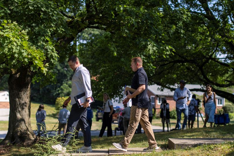 &copy; Reuters. Law enforcement officers walk after speaking with neighbors across the street from the home of 20-year-old Thomas Matthew Crooks, named by the FBI as the "subject involved" in the attempted assassination of former President Donald Trump, in Bethel Park, P