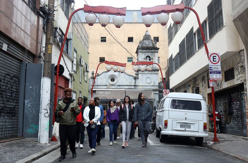 &copy; Reuters. People walk during a tour of Liberdade neighborhood, to learn the Black history of the city arranged  by 'Guia Negro' an organization that aims to disseminate the Black history of the country in Sao Paulo, Brazil, July 13 2024. REUTERS/Felipe Iruata