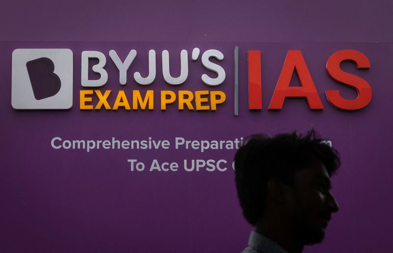 © Reuters. FILE PHOTO: A man walks past an advertising hoarding of Byju's, an Education Technology company and one of India's biggest startup, outside one of its branch in New Delhi, India, June 23, 2023. REUTERS/Adnan Abidi/File Photo