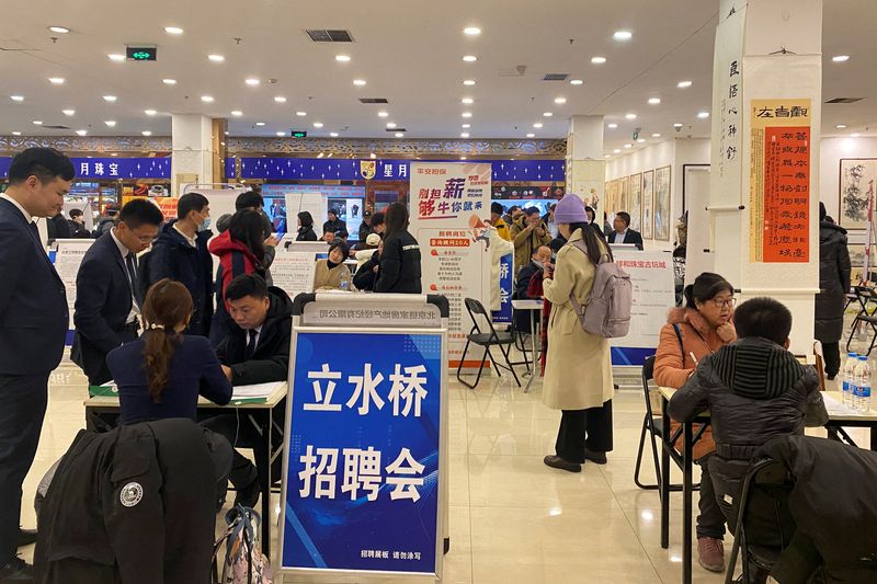 © Reuters. FILE PHOTO: People attend a job fair following the Lunar New Year holiday, in Beijing, China, February 23, 2024. REUTERS/Ellen Zhang/File Photo