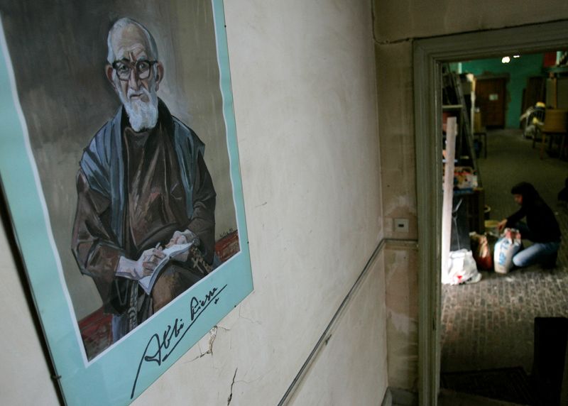 © Reuters. FILE PHOTO: A portrait of French priest Abbe Pierre hangs on a wall at 