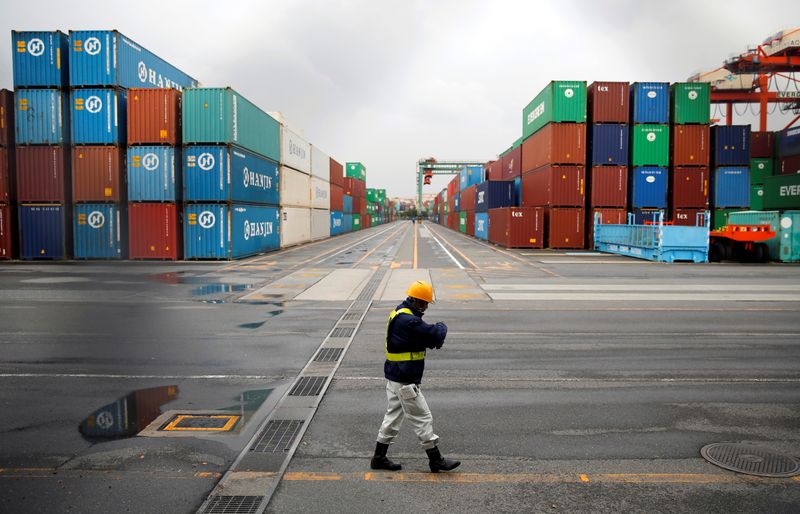 &copy; Reuters. FILE PHOTO: A worker walks in a container area at a port in Tokyo April 21, 2014.  REUTERS/Toru Hanai/File Photo