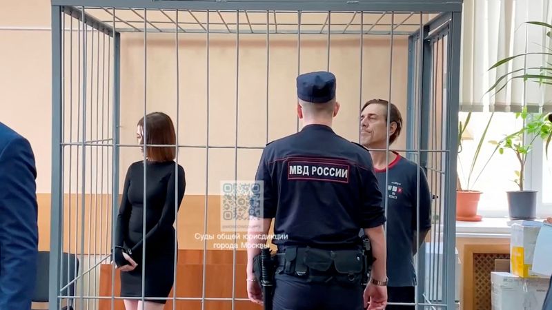 © Reuters. Russian citizen Veronika Grabanchuk and U.S. citizen Michael Travis Leake, accused of drug smuggling, stand inside an enclosure for defendants as they attend a court hearing in Moscow, Russia, in this still image from video, released on July 18, 2024. Moscow City Court Press Service/Handout via REUTERS 