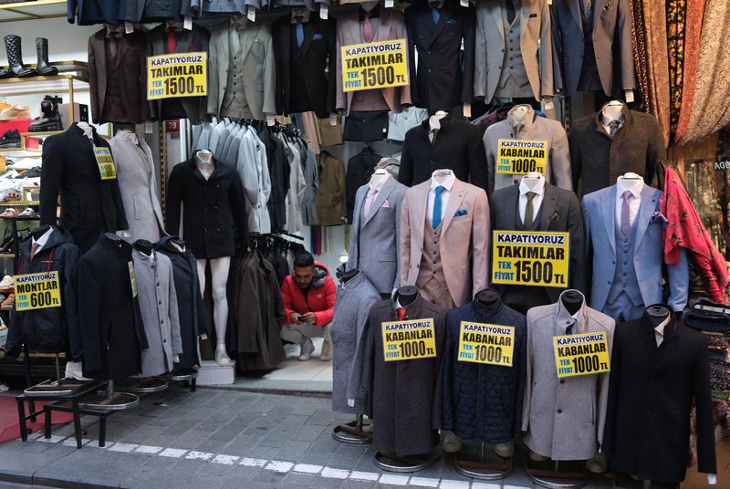 &copy; Reuters. A shopkeeper uses his mobile phone as he waits for customers at a popular middle-class shopping district in Istanbul, Turkey March 4, 2024. REUTERS/Murad Sezer/File photo