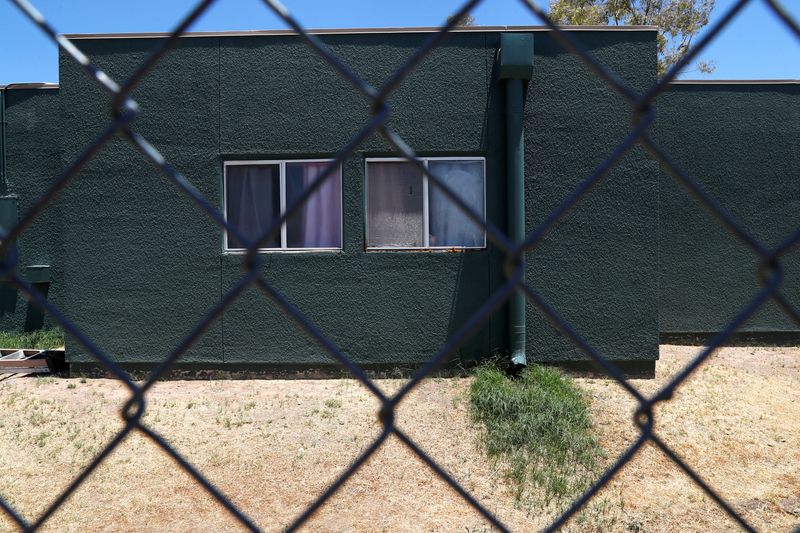 © Reuters. FILE PHOTO: Windows are seen behind chain link fencing at an immigration detention facility for children run by Southwest Key Programs and the U.S. Department of Health and Human Services as U.S. first lady Melania Trump tours the facility in Phoenix, Arizona, U.S., June 28, 2018.    REUTERS/Leah Millis/File Photo