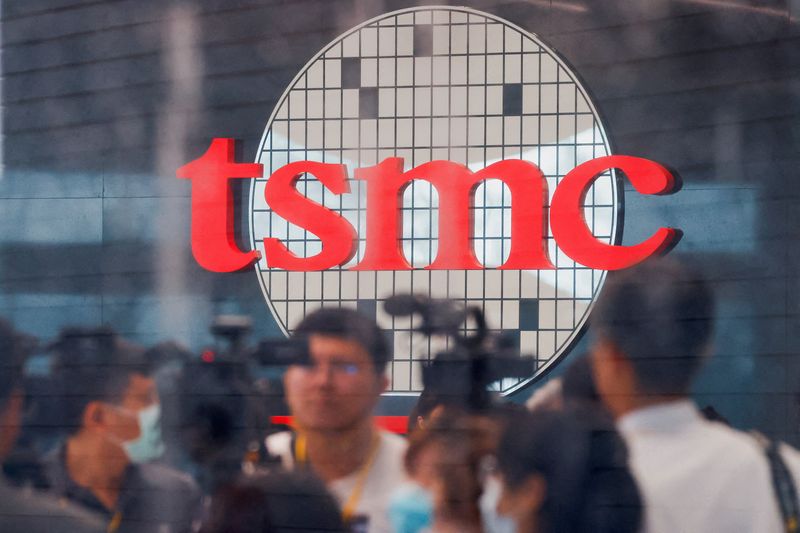 © Reuters. FILE PHOTO: Taiwan Semiconductor Manufacturing Co's logo is seen while people attend the opening of the TSMC global R&D centre in Hsinchu, Taiwan, July 28, 2023. REUTERS/Ann Wang/File Photo