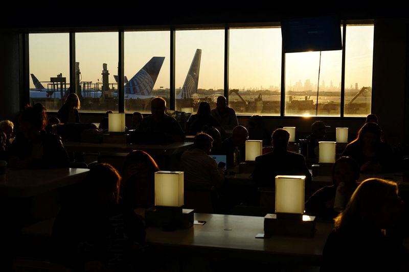 &copy; Reuters. Travelers wait for delayed flights beneath a monitor displaying a blue error screen, also known as the ?Blue Screen of Death? inside Terminal C in Newark International Airport, after United Airlines and other airlines grounded flights due to a worldwide t