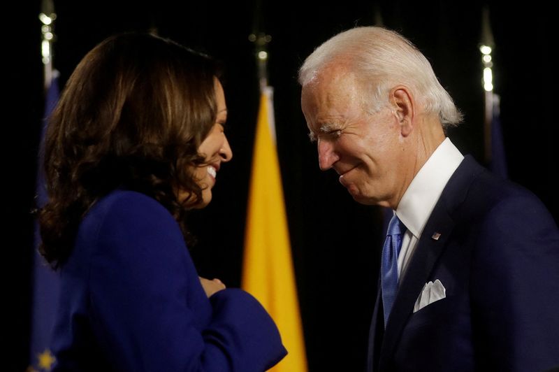 © Reuters. FILE PHOTO: Democratic presidential candidate and former Vice President Joe Biden and vice presidential candidate Senator Kamala Harris are seen at the stage during a campaign event, their first joint appearance since Biden named Harris as his running mate, at Alexis Dupont High School in Wilmington, Delaware, U.S., August 12, 2020. REUTERS/Carlos Barria/File Photo