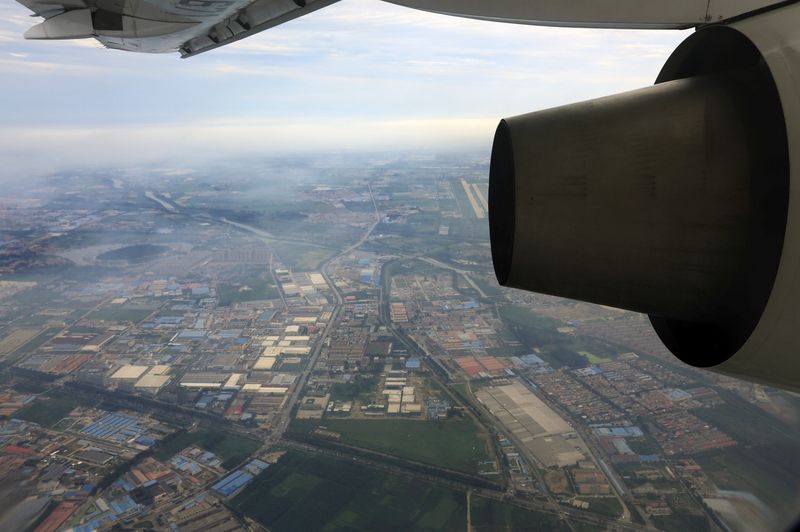 &copy; Reuters. FILE PHOTO: Factories and residential areas are pictured from the window of an aircraft north of Beijing July 29, 2013. REUTERS/Jason Lee/File photo