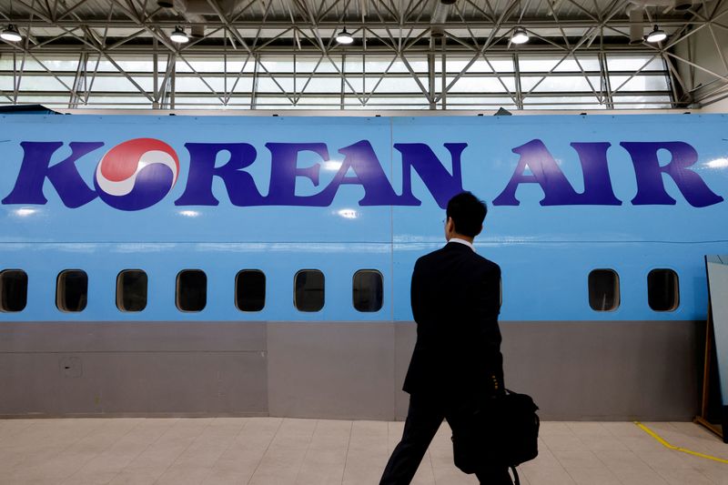 &copy; Reuters. FILE PHOTO: A man walks next to the logo of Korean Air airlines during an organised media tour, at the company's Cabin Crew Training Center in Seoul, South Korea, June 27, 2024. REUTERS/Kim Soo-hyeon/File Photo