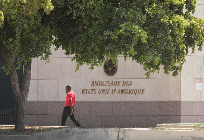 &copy; Reuters. FILE PHOTO: A man walks next the U.S. embassy building where the U.S. military airlifted embassy non-essential personnel due to violence, in Port-au-Prince, Haiti March 10, 2024. REUTERS/Ralph Tedy Erol/File Photo