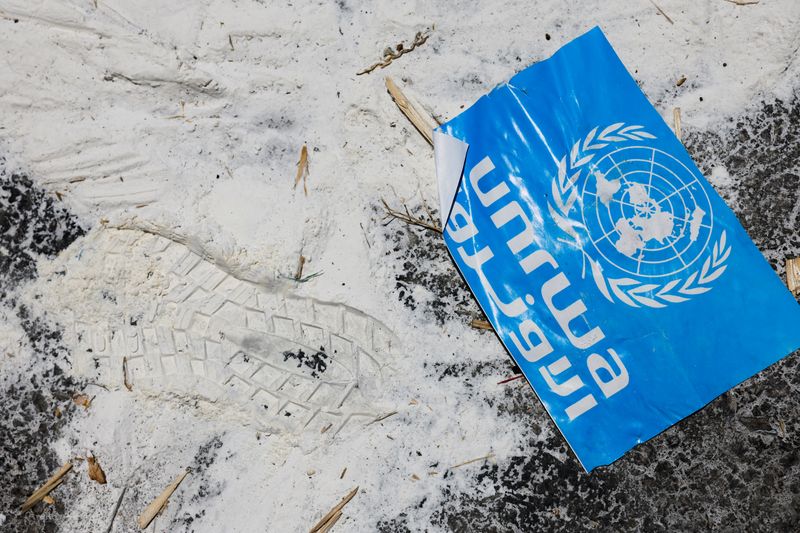 © Reuters. FILE PHOTO: A United Nations Relief and Works Agency (UNRWA) sign lies on the ground, amid the ongoing conflict in Gaza between Israel and the Palestinian Islamist group Hamas,  at the Kerem Shalom crossing in southern Israel, May 30, 2024. REUTERS/Amir Cohen/File Photo