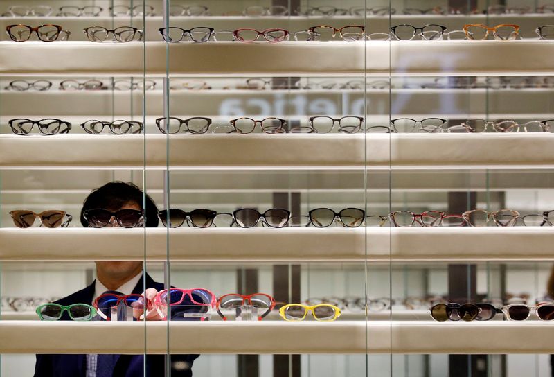 &copy; Reuters. FILE PHOTO: A store assistant adjust eyewear on display in Singapore April 24, 2017.  REUTERS/Edgar Su/File photo