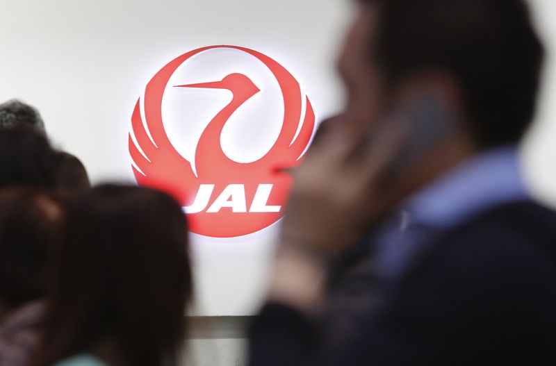 &copy; Reuters. File Photo: Passengers walk past the logo of Japan Airlines (JAL) at Haneda airport in Tokyo April 28, 2013. REUTERS/Yuya Shino/File Photo