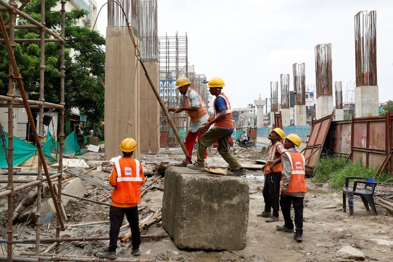 © Reuters. Workers erect a scaffolding to build a pillar at a rail line construction site in Kolkata, India July 23, 2024. REUTERS/Sahiba Chawdhary