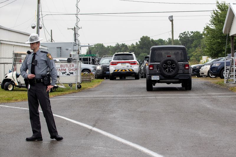 &copy; Reuters. A state trooper stands guard as people are let back into the Butler Farm Show to collect things left behind, four days after the shooting by 20-year-old Thomas Matthew Crooks, named by the FBI as the "subject involved" in the attempted assassination of fo