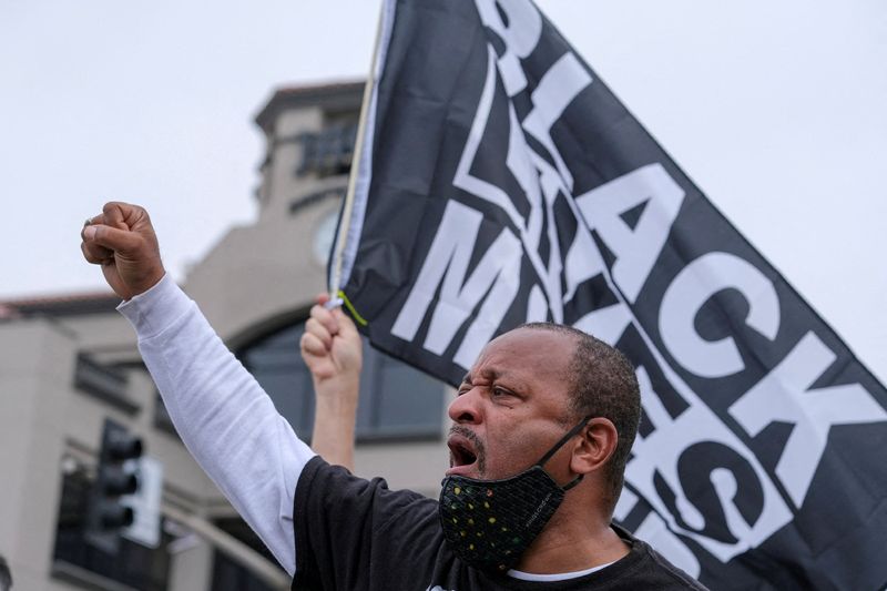 © Reuters. FILE PHOTO: Najee Ali raises his fist and shouts slogans during a Black Lives Matter protest in Huntington Beach, California, U.S. April 11, 2021. REUTERS/Ringo Chiu/File Photo