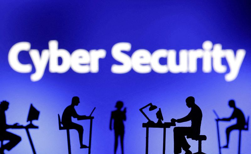 © Reuters. FILE PHOTO: Figurines with computers and smartphones are seen in front of the words 