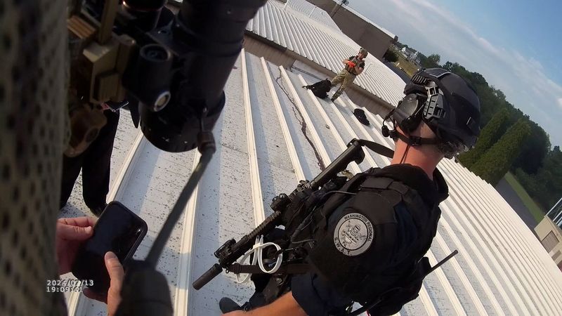 © Reuters. Law enforcement officers stand near the body of a gunman after the assassination attempt on former President Donald Trump during a campaign rally, in Butler, Pennsylvania, U.S., July 13, 2024 in this still image taken from bodycam video.  Beaver Co Emergency Services Unit via Chuck Grassley/Handout via REUTERS     