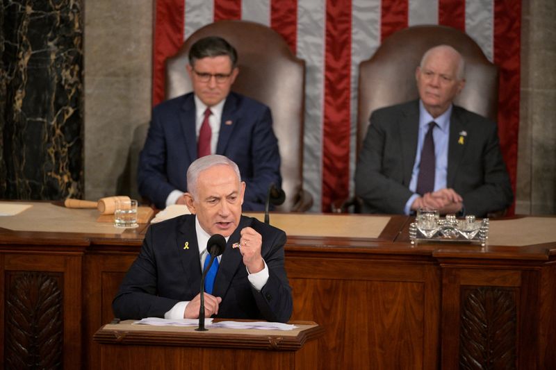 © Reuters. U.S. House Speaker Mike Johnson (R-LA) and Senate Foreign Relations Chair, Senator Ben Cardin (D-MD), listen as Israeli Prime Minister Benjamin Netanyahu addresses a joint meeting of Congress at the U.S. Capitol in Washington, U.S., July 24, 2024. REUTERS/Craig Hudson