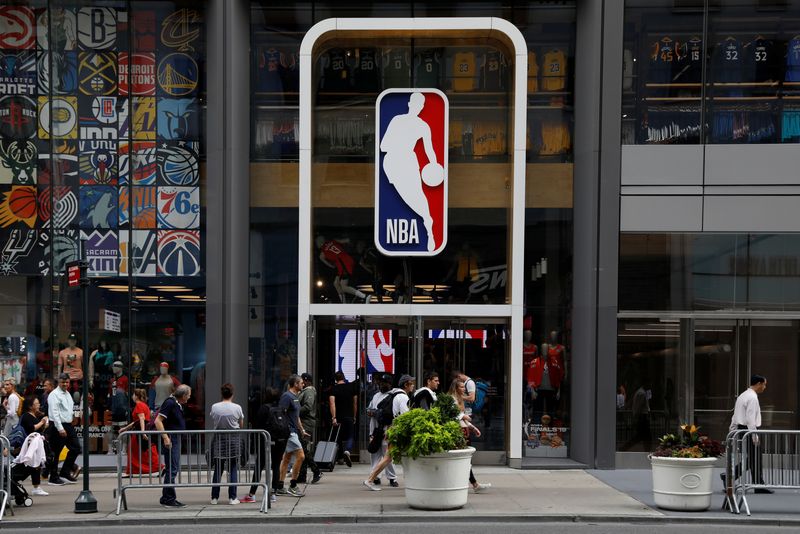 &copy; Reuters. FILE PHOTO: The NBA logo is displayed as people pass by the NBA Store in New York City, U.S., October 7, 2019. REUTERS/Brendan McDermid/File Photo