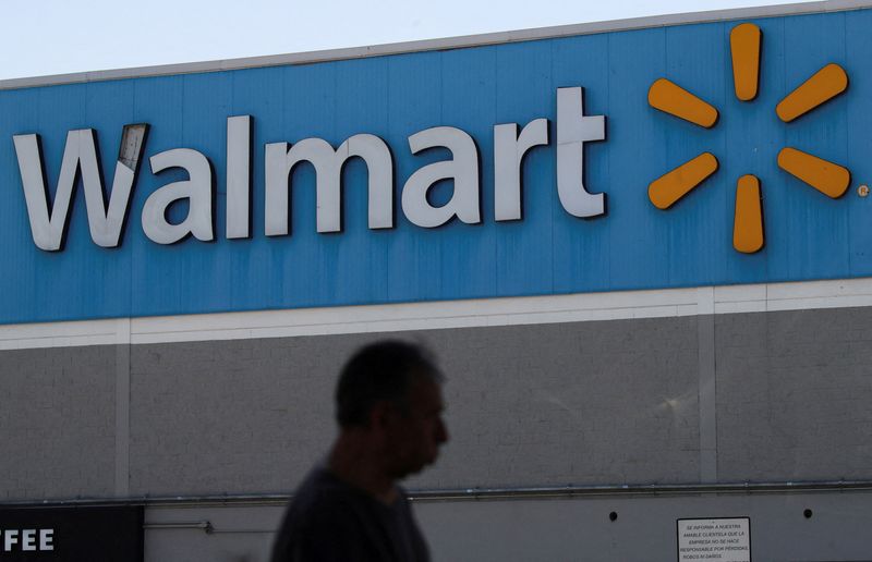 © Reuters. FILE PHOTO: A man walks past the logo of Walmart on the facade at a store in Mexico City, Mexico June 17, 2024. REUTERS/Henry Romero/File Photo