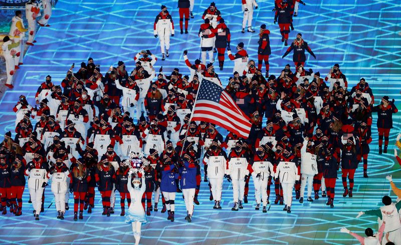 © Reuters. FILE PHOTO: 2022 Beijing Olympics - Opening Ceremony - National Stadium, Beijing, China - February 4, 2022. Flag bearers Elana Meyers Taylor of the United States and John Shuster of the United States lead their contingent during the athletes parade at the opening ceremony. REUTERS/David W Cerny/File Photo