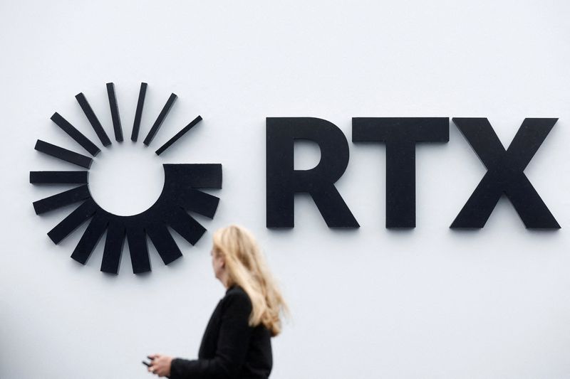 &copy; Reuters. FILE PHOTO: Visitor passes the Raytheon Technologies Corporation (RTX) logo at the 54th International Paris Air Show at Le Bourget Airport near Paris, France, June 22, 2023. REUTERS/Benoit Tessier/File Photo