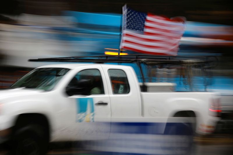 &copy; Reuters. FILE PHOTO: A PG&E truck carrying an American Flag drives past PG&E repair trucks in Paradise, California, U.S. November 21, 2018.  REUTERS/Elijah Nouvelage/File Photo