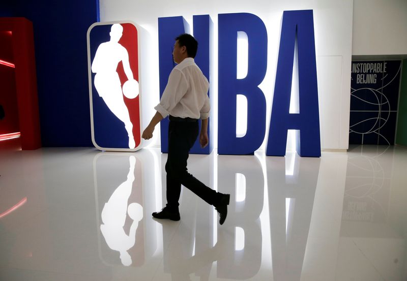 &copy; Reuters. FILE PHOTO: A man walks past an NBA logo at an NBA exhibition in Beijing, China October 8, 2019. REUTERS/Jason Lee/File Photo