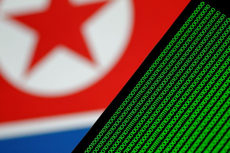 © Reuters. FILE PHOTO: Binary code is seen on a screen against a North Korean flag in this illustration photo November 1, 2017. REUTERS/Thomas White/Illustration/File Photo