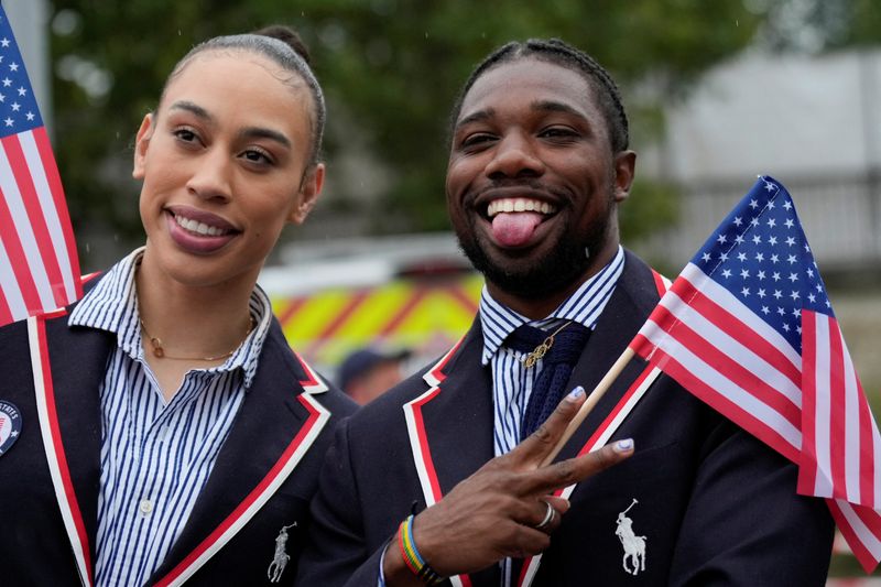 &copy; Reuters. Paris 2024 Olympics - Opening Ceremony - Paris, France - July 26, 2024. Noah Lyles of United States poses for photos while traveling along the Seine River in Paris, France, during the opening ceremony of the Paris 2024 Summer Olympics. Ashley Landis/Pool 