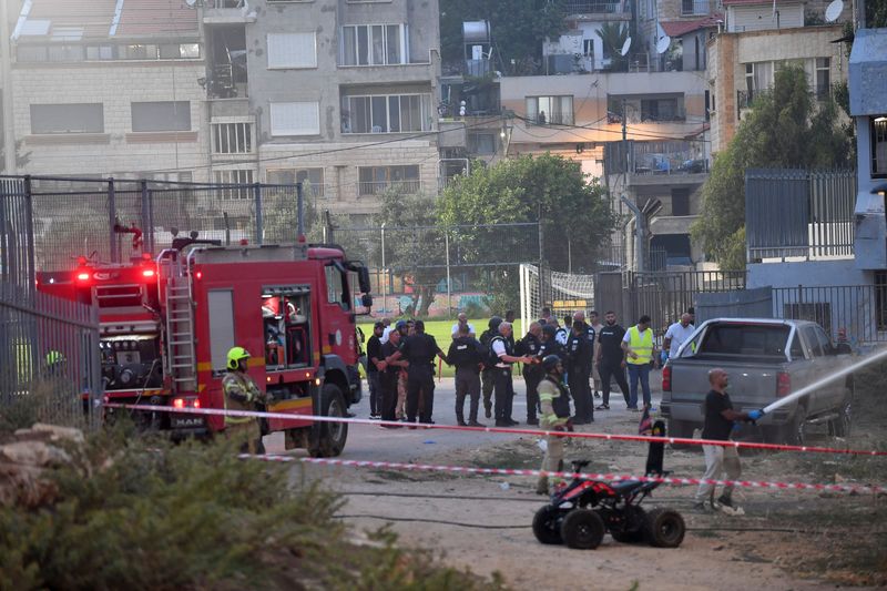 © Reuters. Israeli officials respond after rockets were launched across Lebanon’s border with Israel which, according to Israel’s ambulance services critically injured multiple people at a soccer pitch in Majdal Shams, a Druze village in the Israeli-occupied Golan Heights, July 27 2024. REUTERS/Gil Eliyahu 