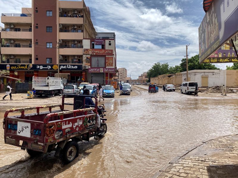 &copy; Reuters. FILE PHOTO: A person drives a vehicle through a flooded street, following a heavy rainfall in Kassala, eastern Sudan, July 26, 2024. REUTERS/Mohammed Abdel Majid/File Photo